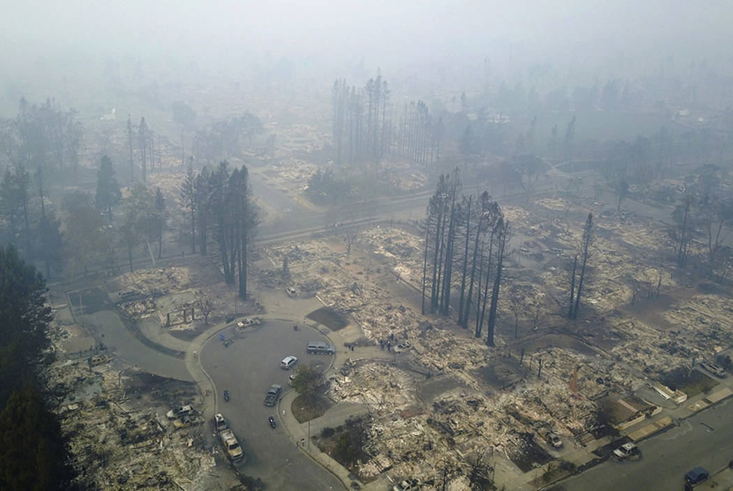 This aerial image shows a neighborhood that was destroyed by a wildfire in Santa Rosa, Calif., Tuesday, Oct. 10, 2017. Newly homeless residents of California wine country took stock of their shatt ...