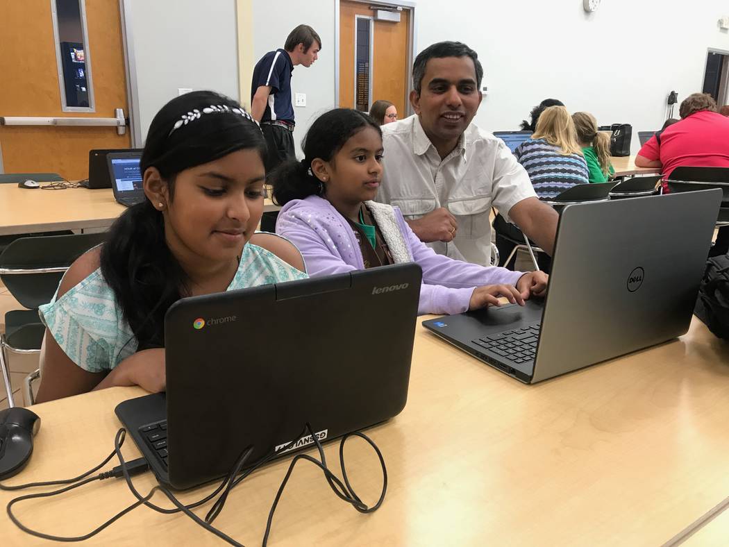 Girl Scouts Savia and Sonel practice coding activities with their father on Oct. 9, 2017 at the Girl Scouts of Southern Nevada headquarters, 2941 E. Harris Ave. (Kailyn Brown/View) @KailynHype