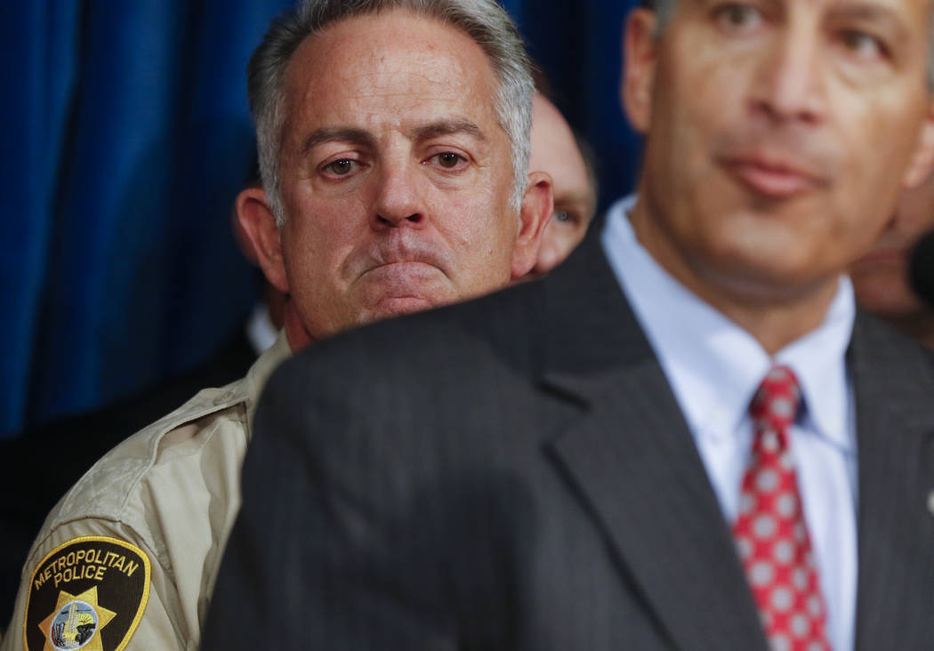 Clark County Sheriff Joe Lombardo, left, and listens as Gov. Brian Sandoval speaks at Metropolitan Police Department headquarters in Las Vegas on Wednesday, Oct. 4, 2017. A gunman opened fire on a ...