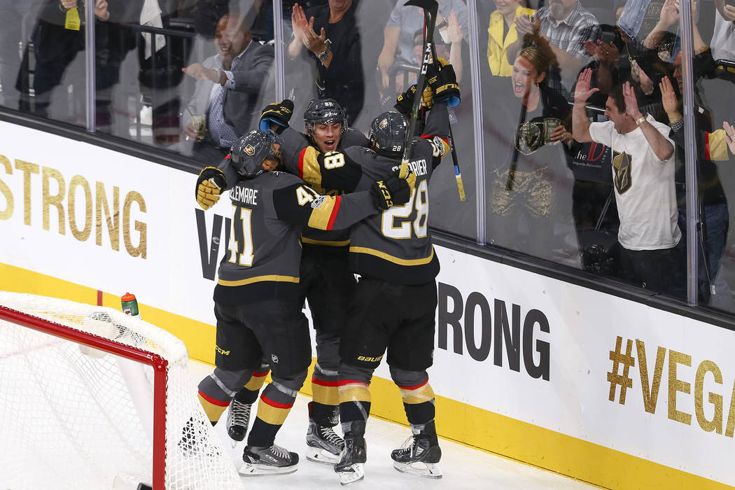 Vegas Golden Knights left wing Tomas Nosek (92) celebrates with Knights Pierre-Edouard Bellemare (41) and William Carrier (28) after scoring during the first period of an NHL hockey game between t ...