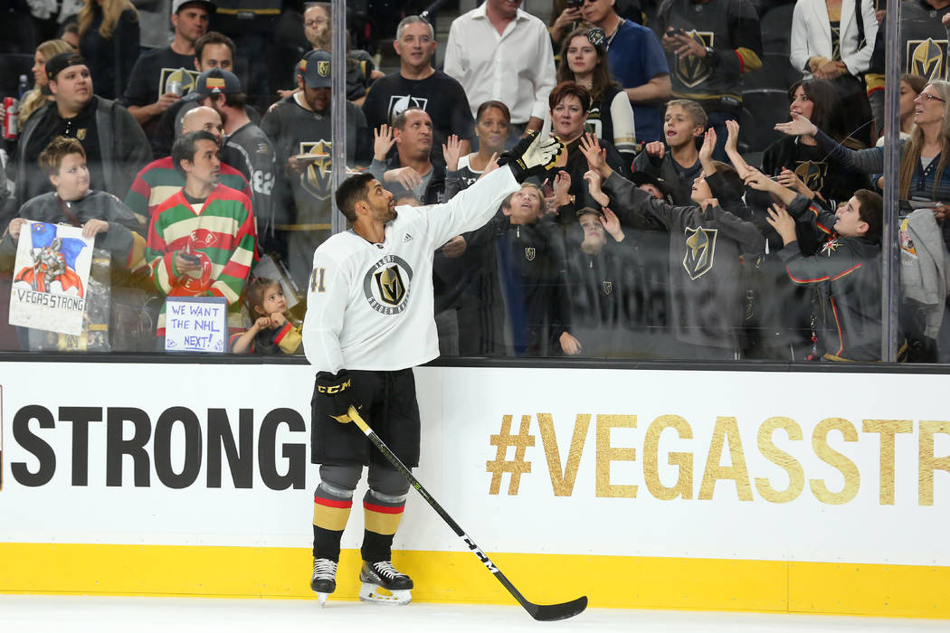 Vegas Golden Knights left wing Pierre-Edouard Bellemare (41) throws a puck over the glass for fans before the game against the Arizona Coyotes at T-Mobile Arena in Las Vegas, Tuesday, Oct. 10, 201 ...