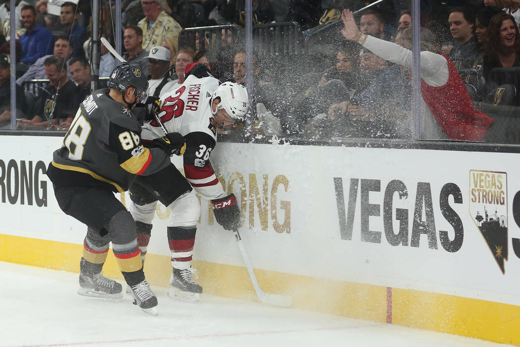 Vegas Golden Knights defenseman Nate Schmidt (88) checks Arizona Coyotes right wing Christian Fischer (36) into the glass during the third period against the Arizona Coyotes at T-Mobile Arena in L ...
