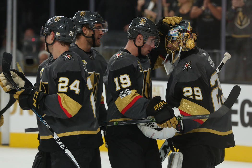 Vegas Golden Knights right wing Reilly Smith (19) and Vegas Golden Knights goalie Marc-Andre Fleury (29) embrace after the third period against the Arizona Coyotes at T-Mobile Arena in Las Vegas,  ...
