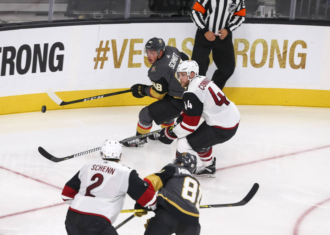 Vegas Golden Knights defenseman Nate Schmidt (88) and Arizona Coyotes defenseman Kevin Connauton (44) chase the puck during the second period of an NHL hockey game between the Vegas Golden Knights ...