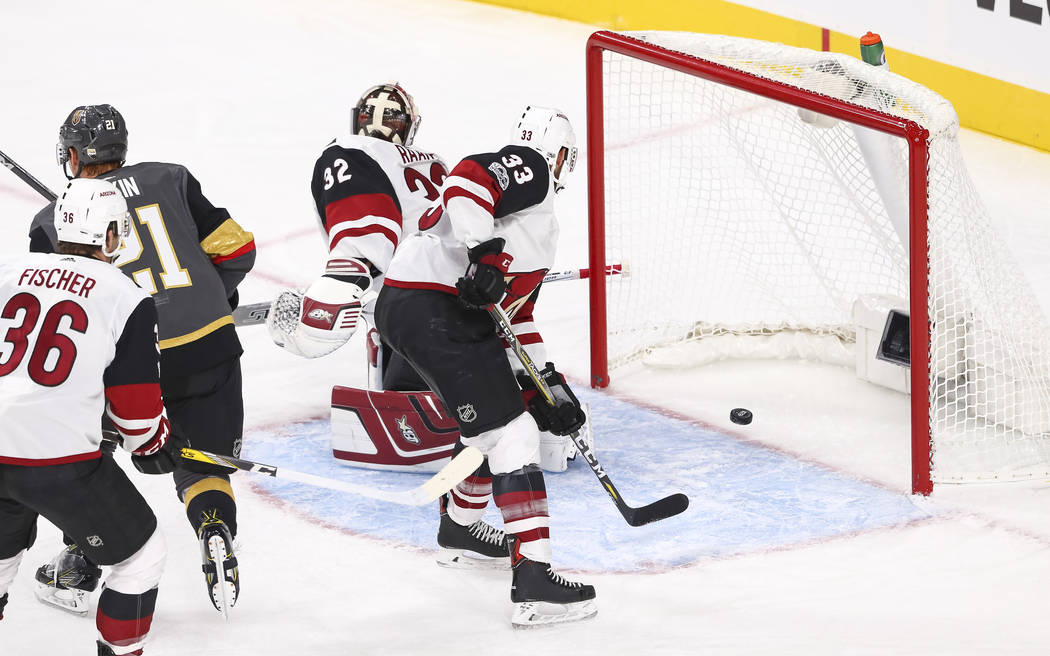 A puck shot by Vegas Golden Knights left wing James Neal, not shown, gets past Arizona Coyotes goalie Antti Raanta (32) during the first period of an NHL hockey game between the Vegas Golden Knigh ...