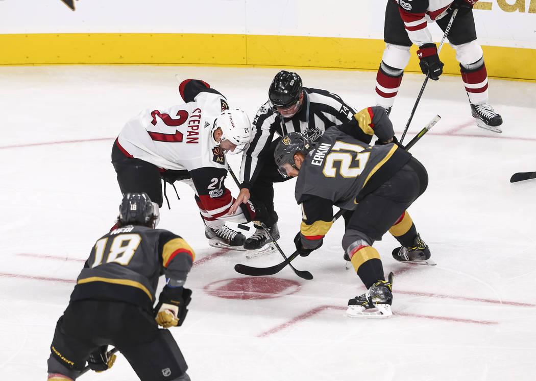 Arizona Coyotes center Derek Stepan (21) and Vegas Golden Knights center Cody Eakin (21) face off during the second period of an NHL hockey game between the Vegas Golden Knights and the Arizona Co ...