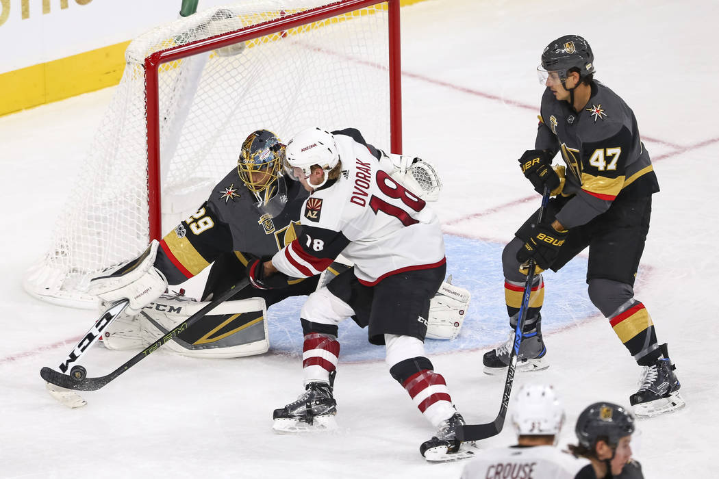 Vegas Golden Knights goalie Marc-Andre Fleury (29) deflects a shot from Arizona Coyotes center Christian Dvorak (18) during the third period of an NHL hockey game between the Vegas Golden Knights ...