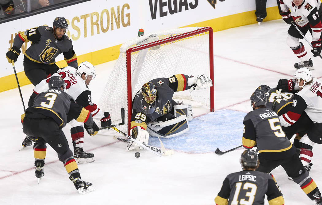 Vegas Golden Knights goalie Marc-Andre Fleury (29) deflects a shot from Arizona Coyotes right wing Christian Fischer (36) during the third period of an NHL hockey game between the Vegas Golden Kni ...
