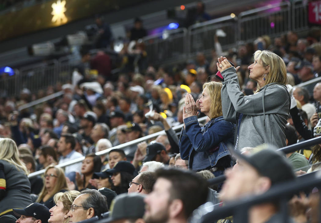 Fans cheer for first responders and victims of the mass shooting in Las Vegas before the start of an NHL hockey game at T-Mobile Arena between Golden Knights and Arizona Coyotes on Tuesday, Oct. 1 ...