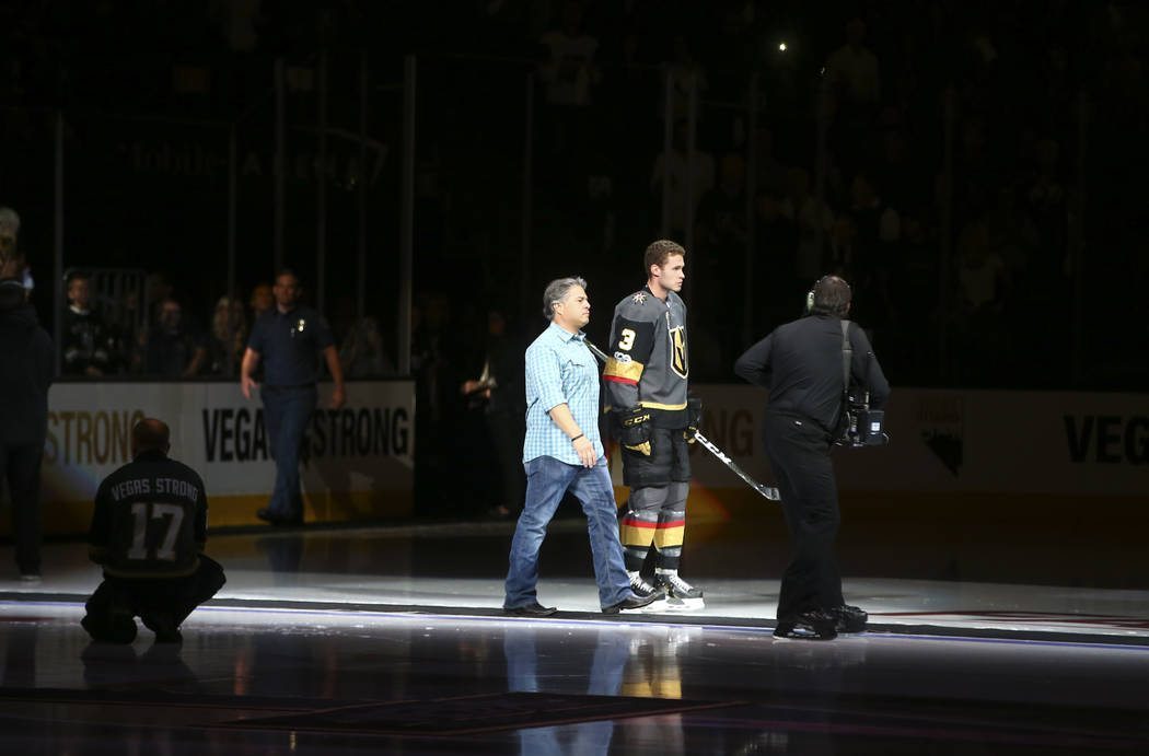 Vegas Golden Knights' Brayden McNabb (3) is introduced with a first responder before playing the Arizona Coyotes in an NHL hockey game at T-Mobile Arena in Las Vegas on Tuesday, Oct. 10, 2017. Cha ...