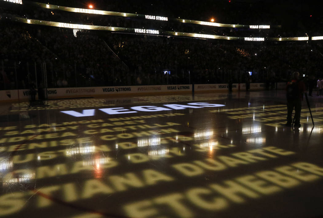 Names of victims in the mass shooting in Las Vegas are displayed on the ice before an NHL hockey game between the Vegas Golden Knights and Arizona Coyotes at T-Mobile Arena in Las Vegas on Tuesday ...