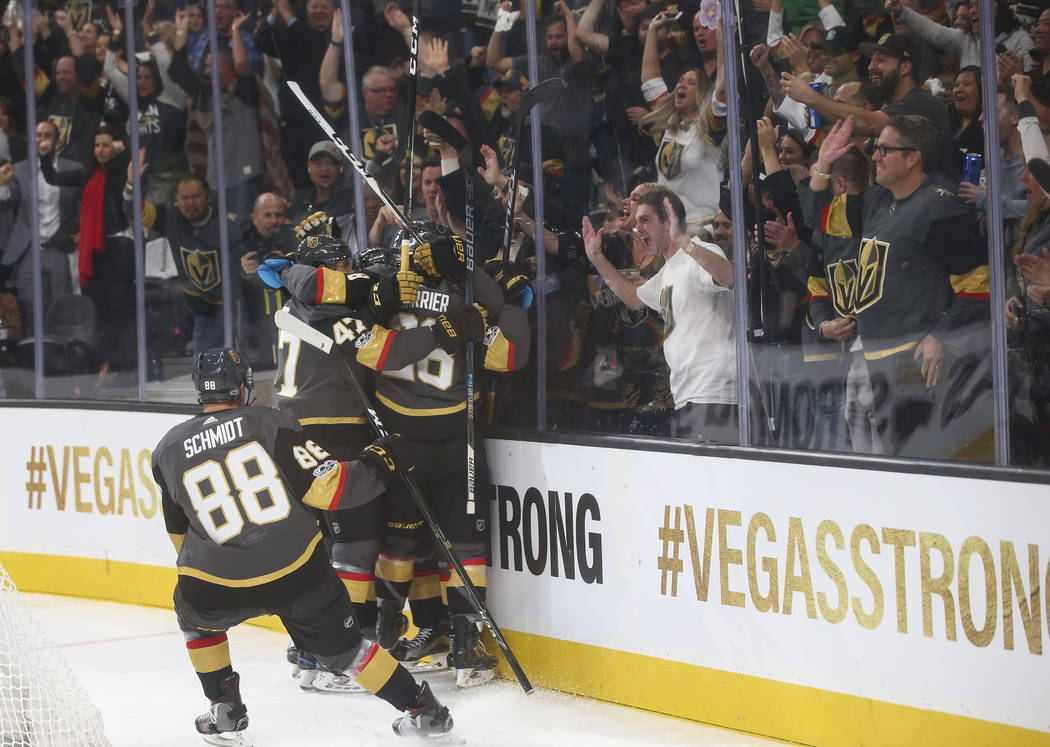 Vegas Golden Knights players celebrate the first goal of the night, by Tomas Nosek, against the Arizona Coyotes during an NHL hockey game at T-Mobile Arena in Las Vegas on Tuesday, Oct. 10, 2017. ...