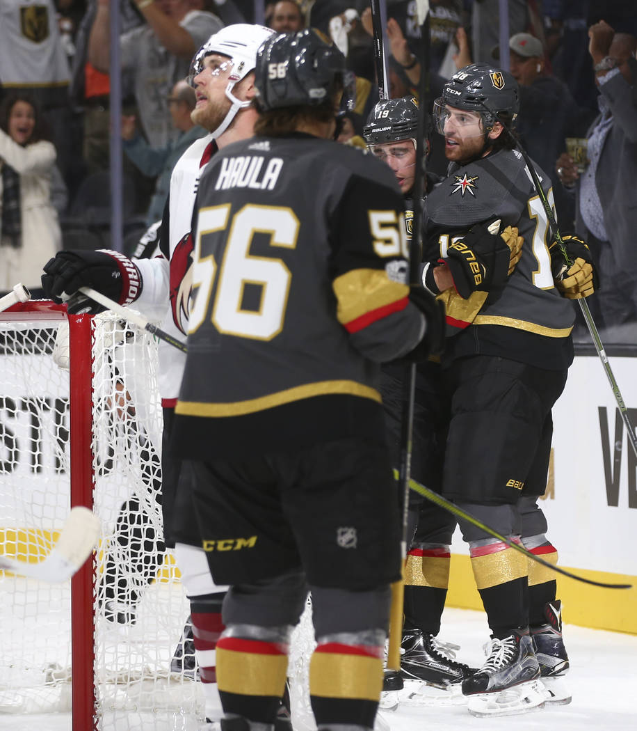 Vegas Golden Knights' James Neal, far right, is embraced by teammate Reilly Smith (19) after Neal scored the fourth goal against the Arizona Coyotes during an NHL hockey game at T-Mobile Arena in  ...