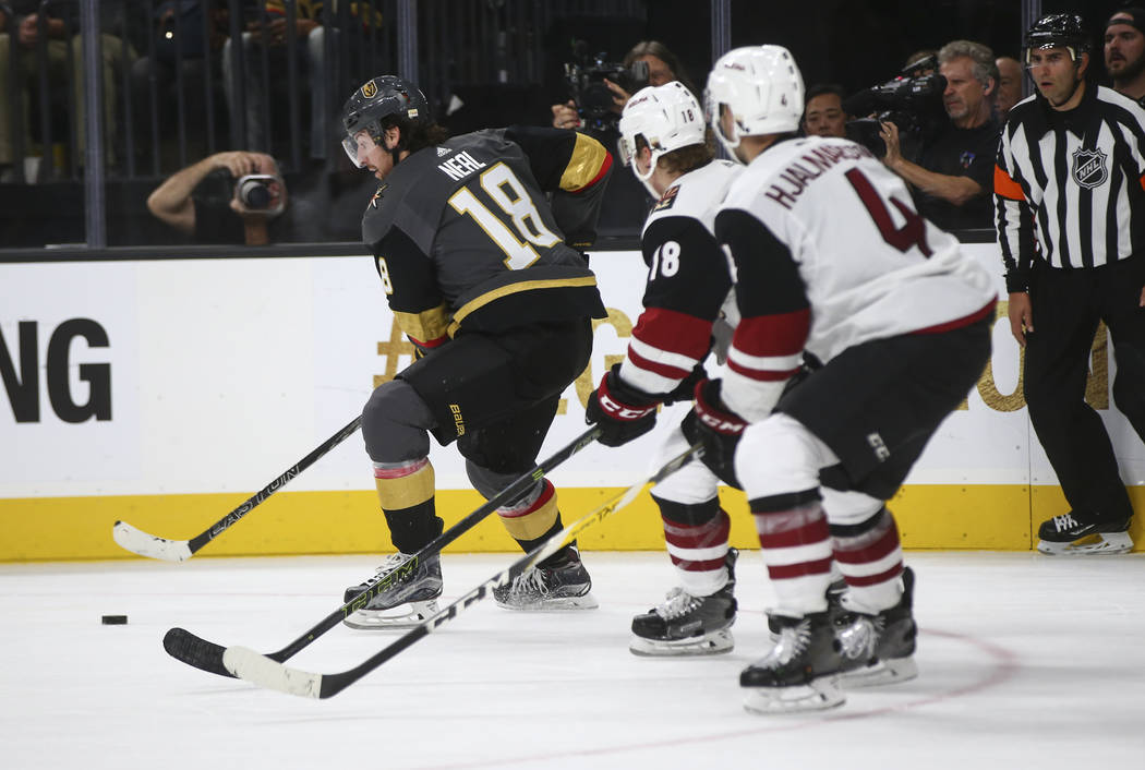 Vegas Golden Knights' James Neal (18) moves the puck as Arizona Coyotes defenders follow during an NHL hockey game at T-Mobile Arena in Las Vegas on Tuesday, Oct. 10, 2017. The Golden Knights won  ...