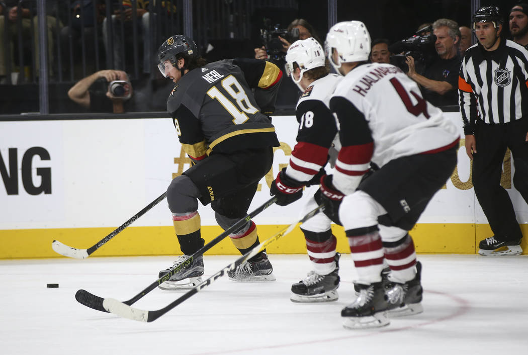 Vegas Golden Knights' James Neal (18) moves the puck as Arizona Coyotes defenders follow during an NHL hockey game at T-Mobile Arena in Las Vegas on Tuesday, Oct. 10, 2017. The Golden Knights won ...