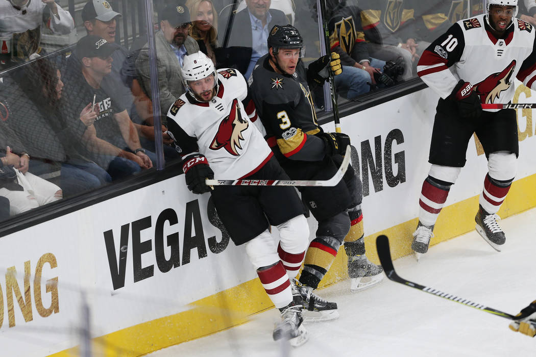 Vegas Golden Knights defenseman Brayden McNabb (3) is pushed to the wall in the NHL season home opener against  Arizona Coyotes right wing Tobias Rieder (8) at T-Mobile Arena in Las Vegas, Tuesday ...