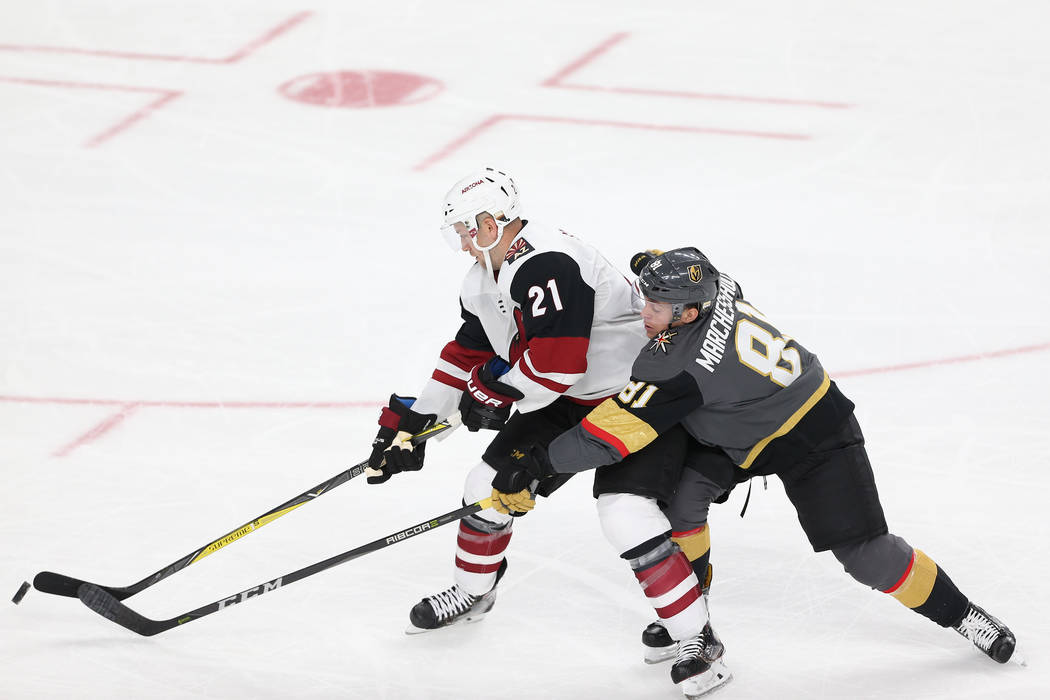 Arizona Coyotes center Derek Stepan (21) battle for procession against Vegas Golden Knights center Jonathan Marchessault (81) in the Knight's NHL season home opener at T-Mobile Arena in Las Vegas, ...