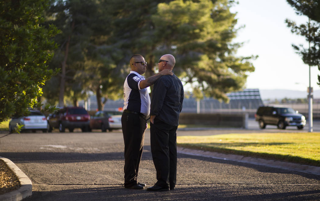 Supervisor and friend Gus A. Vega, left, comforts a coworker during a memorial service for Erick Silva, who they worked with at Contemporary Services Corporation, at Davis Funeral Home in Las Vega ...