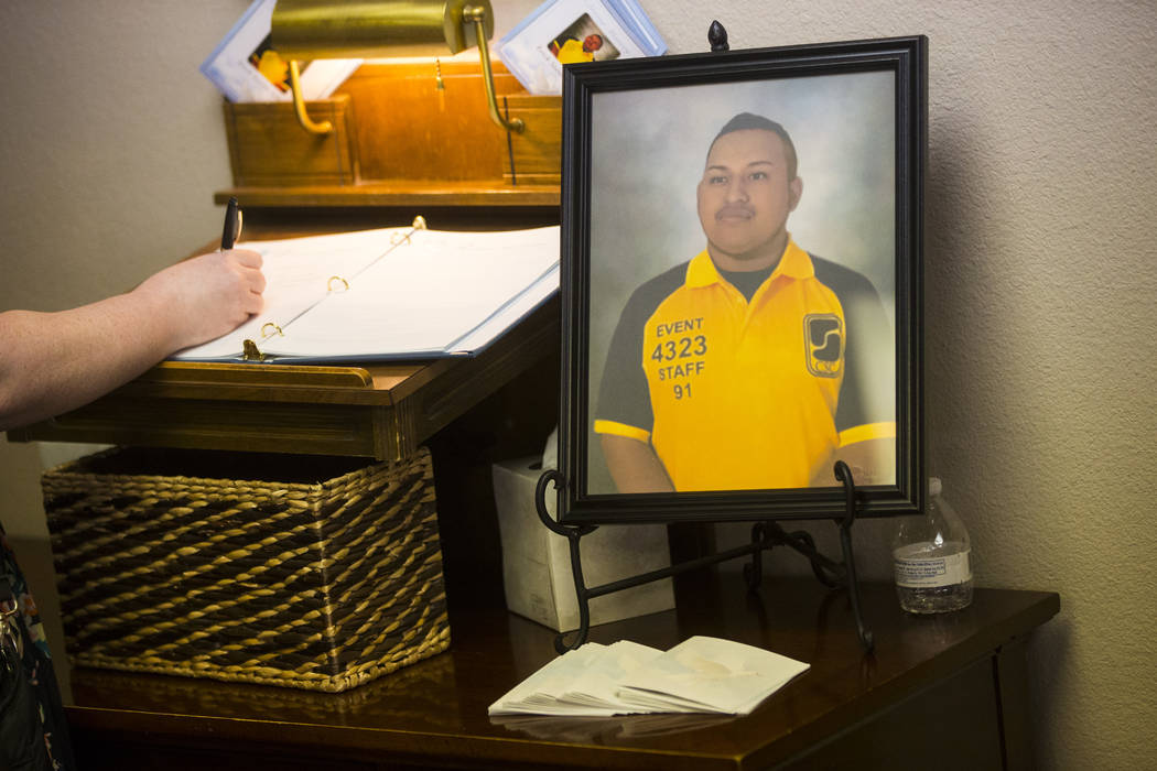 People sign a guestbook during a memorial service for Erick Silva at Davis Funeral Home in Las Vegas on Wednesday, Oct. 11, 2017. Silva was working as a security guard at the Route 91 Harvest fest ...