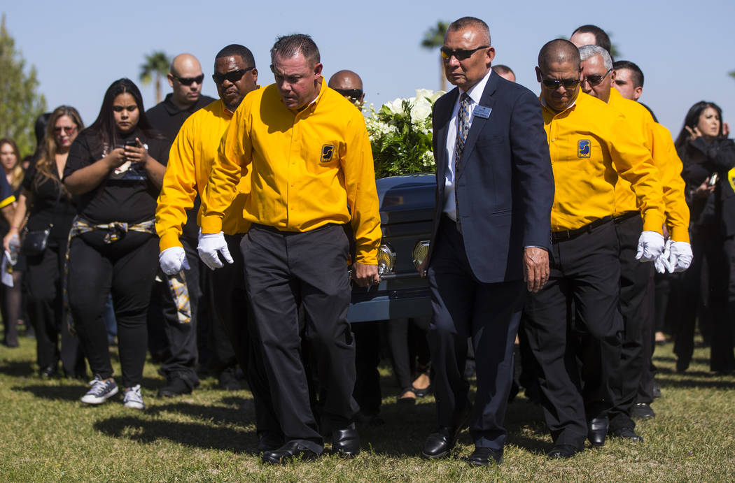 Pallbearers carry the casket of Erick Silva during funeral services at Davis Funeral Home & Memorial Park in Las Vegas on Thursday, Oct. 12, 2017. Silva was working as a security guard at the ...