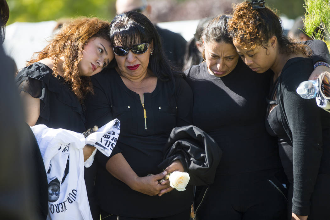 Sixteen-year-old Chantal Sosa, left, comforts her mother Angelica Cervantes during funeral services for Erick Silva at Davis Funeral Home & Memorial Park in Las Vegas on Thursday, Oct. 12, 201 ...