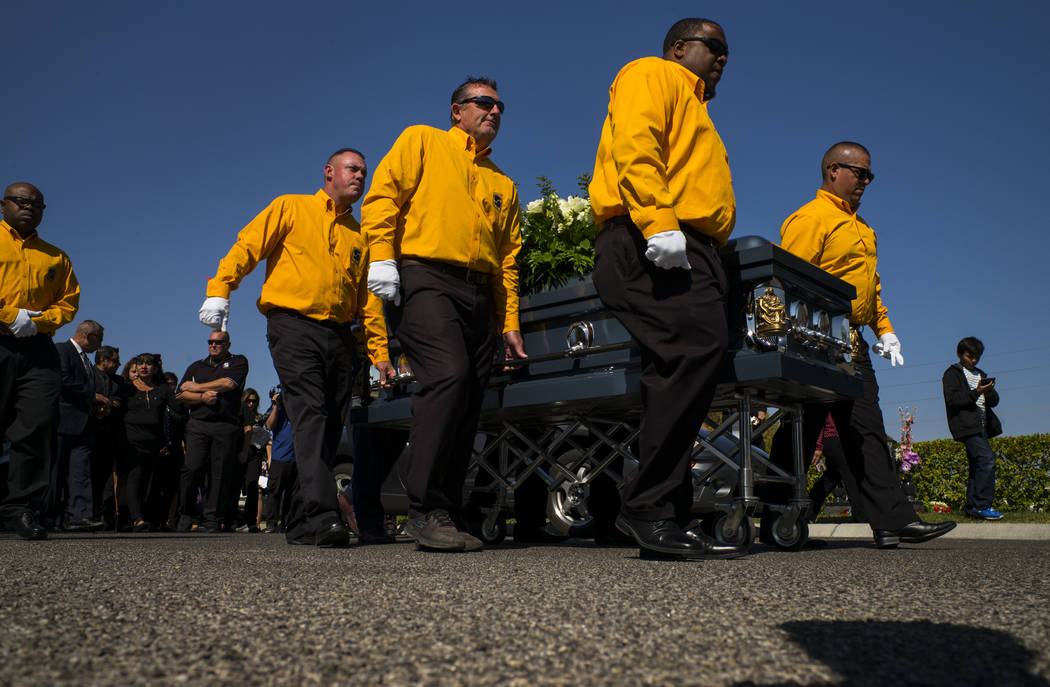 Pallbearers carry the casket of Erick Silva during funeral services at Davis Funeral Home & Memorial Park in Las Vegas on Thursday, Oct. 12, 2017. Silva was working as a security guard at the ...