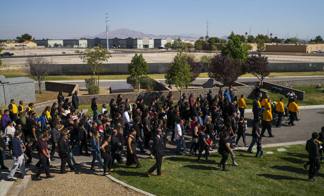 Pallbearers carry the casket of Erick Silva during funeral services at Davis Funeral Home & Memorial Park in Las Vegas on Thursday, Oct. 12, 2017. Silva was working as a security guard at the ...