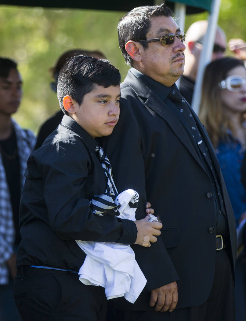 Son Arturo De La Rosa, and stepfather Gregorio De La Rosa, during funeral services for Erick Silva, at Davis Funeral Home & Memorial Park in Las Vegas on Thursday, Oct. 12, 2017. Silva was wor ...