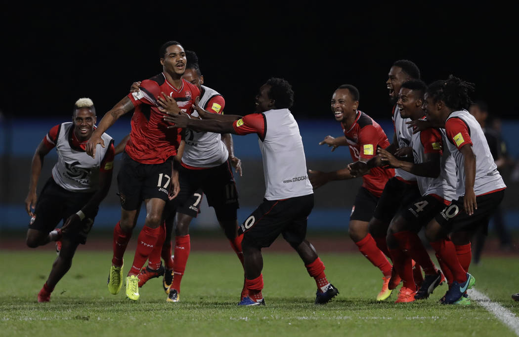 Trinidad and Tobago's Alvin Jones (17) celebrates with his teammates after scoring against U.S. during a World Cup qualifying soccer match in Couva, Trinidad, Tuesday, Oct. 10, 2017. (AP Photo/Reb ...