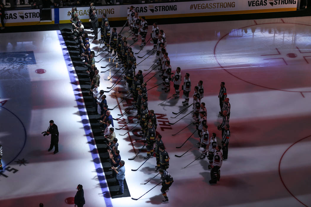 Victims and first responders of the Route 91 Harvest Festival shooting are honored before the start of an NHL hockey game between the Vegas Golden Knights and the Arizona Coyotes at T-Mobile Arena ...