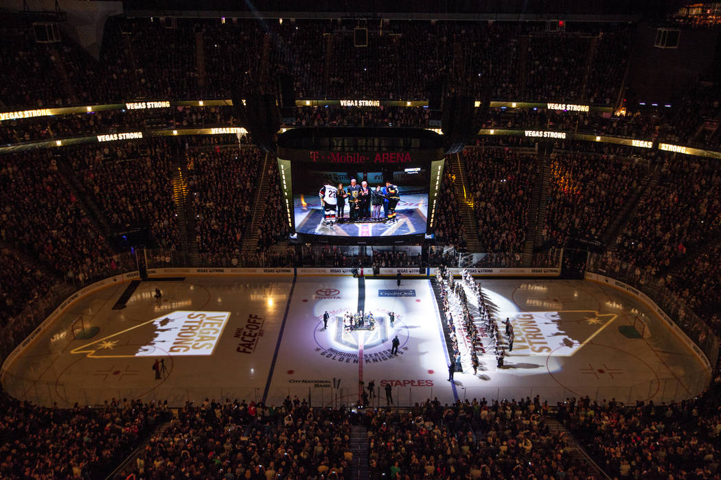 Names of the 58 people killed in the Route 91 Harvest Festival shooting are displayed on the hockey ring before the start of an NHL hockey game between the Vegas Golden Knights and the Arizona Coy ...