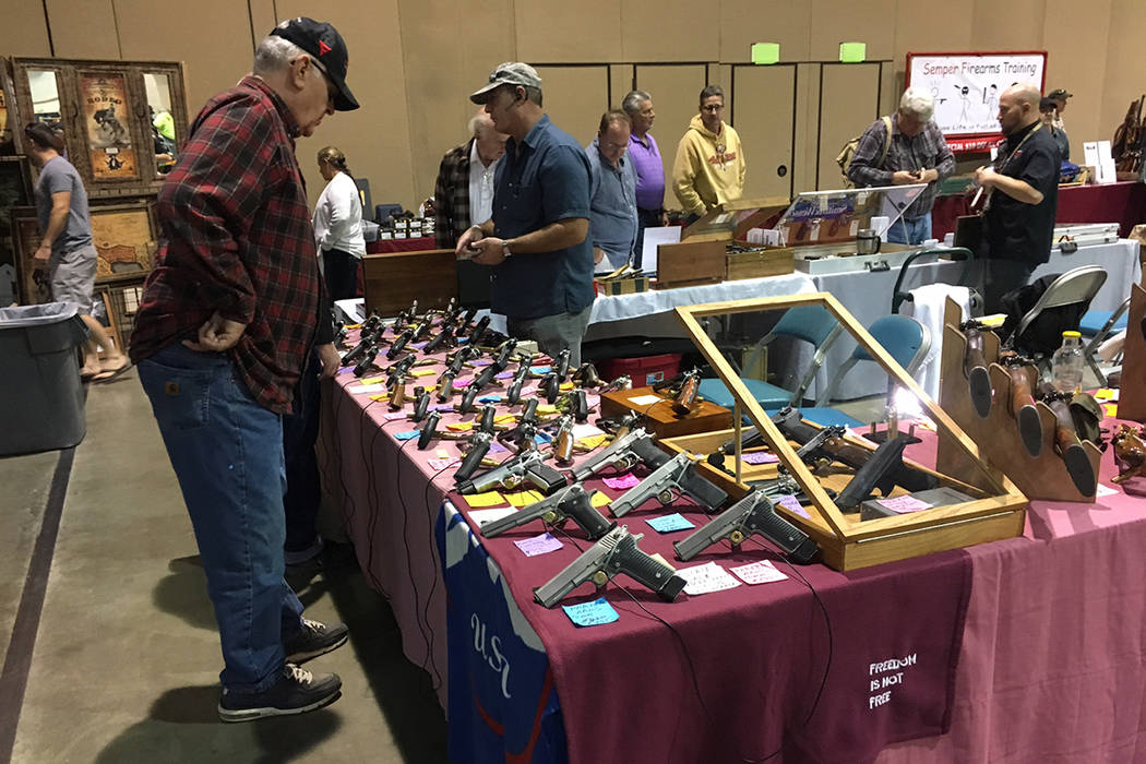 A potential customer looks over the merchandise at one booth at the Crossroads of the West Gun Show held in Reno on Saturday, Oct. 7, 2017. Sean Whaley Las Vegas Review-Journal