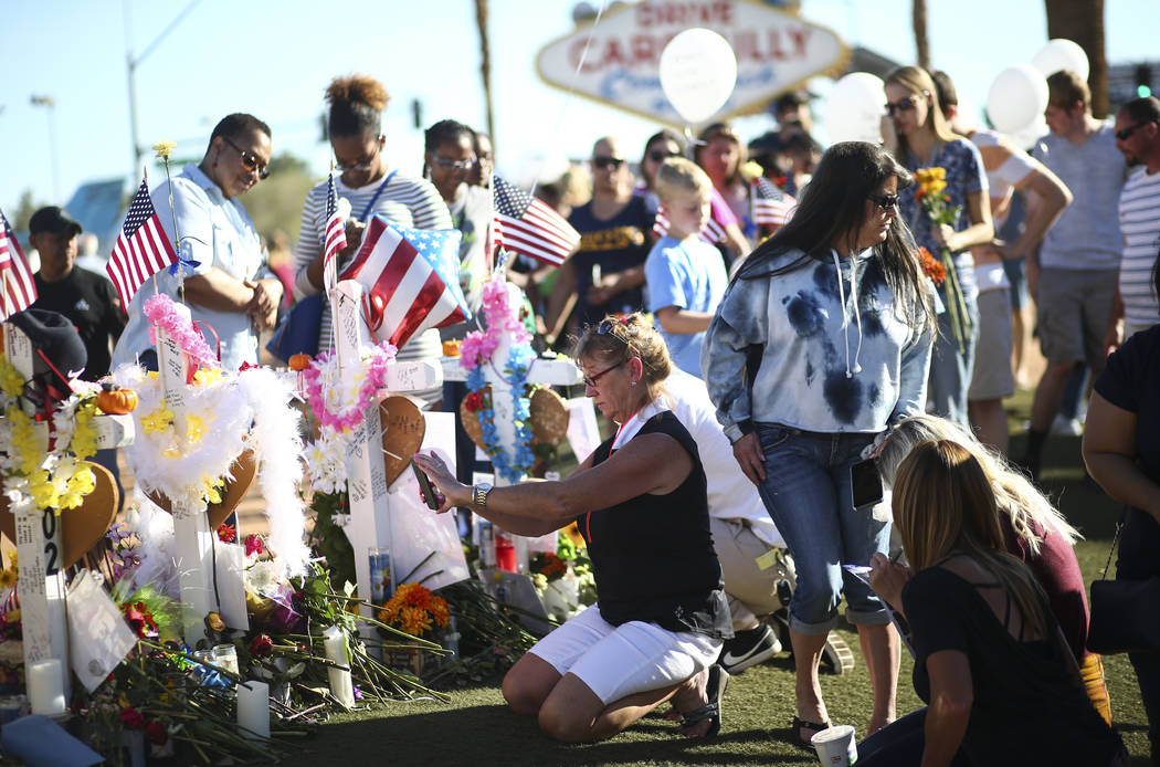 People visit a makeshift memorial for victims of the mass shooting near the "Welcome to Fabulous Las Vegas" sign in Las Vegas on Saturday, Oct. 7, 2017. Chase Stevens Las Vegas Review-Journal @css ...