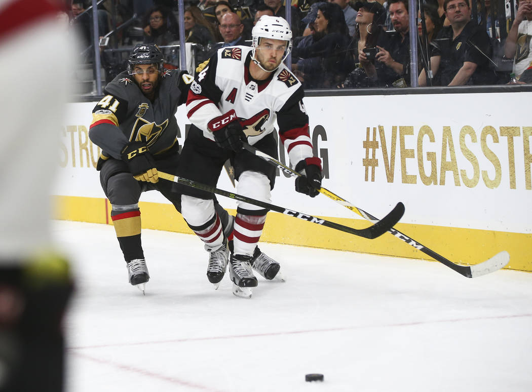Vegas Golden Knights' Pierre-Edouard Bellemare (41) and Arizona Coyotes' Niklas Hjalmarsson (4) go after the puck during an NHL hockey game at T-Mobile Arena in Las Vegas on Tuesday, Oct. 10, 2017 ...