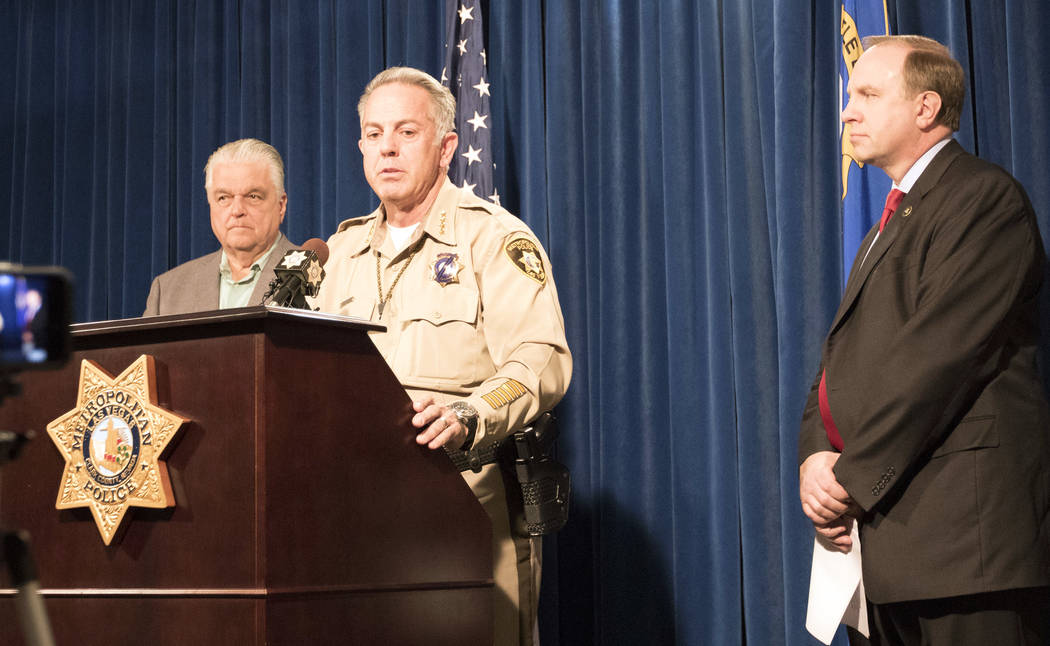 Clark Country Commission Chairman Steve Sisolak, left, Sheriff Joe Lombardo, center, and FBI special agent Aaron Rouse at a news briefing at the Metropolitan Police Department in Las Vegas, Friday ...