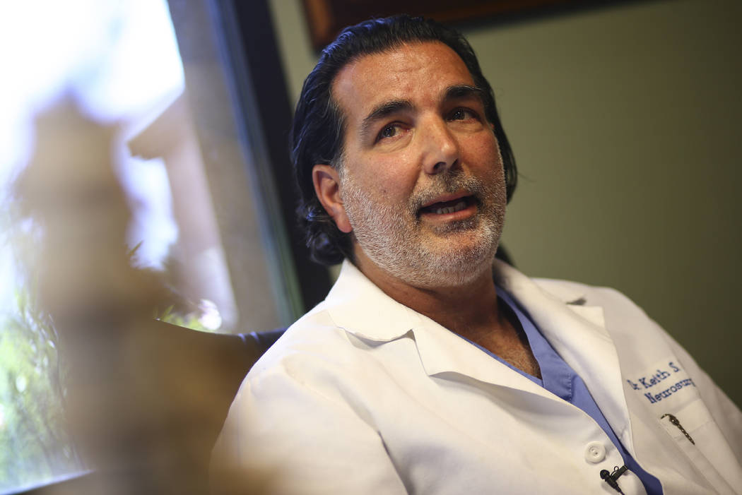Dr. Keith Blum, a neurosurgeon who was on call at Sunrise Hospital and Medical Center the night of the mass shooting, looks at brain scans of patient Tina Frost at his office in Las Vegas on Wedne ...