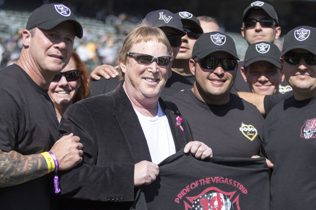First responders from the Las Vegas shooting meet with Oakland Raiders owner Mark Davis (white shirt) before the game against the Los Angeles Chargers in Oakland, Calif., Sunday, Oct. 15, 2017. He ...
