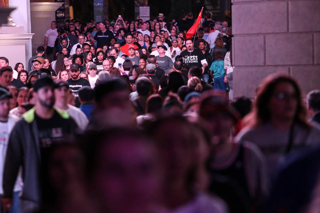 People walk along the Strip during the Vegas Strong Las Vegas Strip Walk honoring the victims of the Route 91 Harvest Festival shooting in Las Vegas, Sunday, Oct. 15, 2017. Joel Angel Juarez Las V ...
