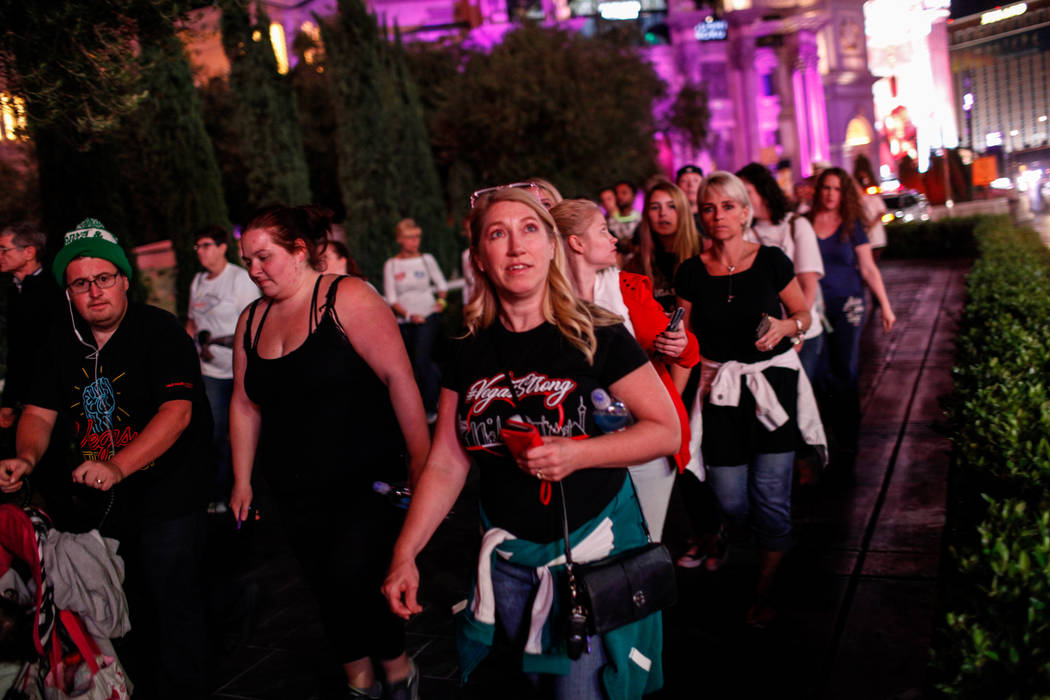 Denise Andrini of Las Vegas, 45, walks along the Strip during the Vegas Strong Las Vegas Strip Walk honoring the victims of the Route 91 Harvest Festival shooting in Las Vegas, Sunday, Oct. 15, 20 ...