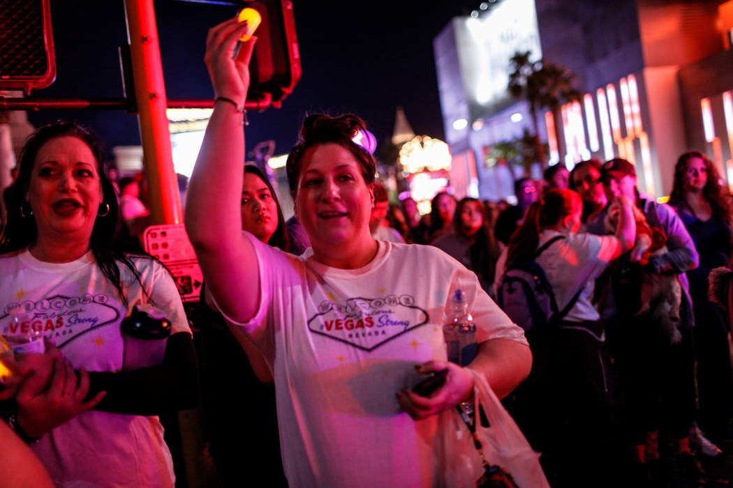 Jennifer Levine of Las Vegas, 37, right, holds a candle as she walks along the Strip during the Vegas Strong Las Vegas Strip Walk honoring the victims of the Route 91 Harvest Festival shooting in  ...