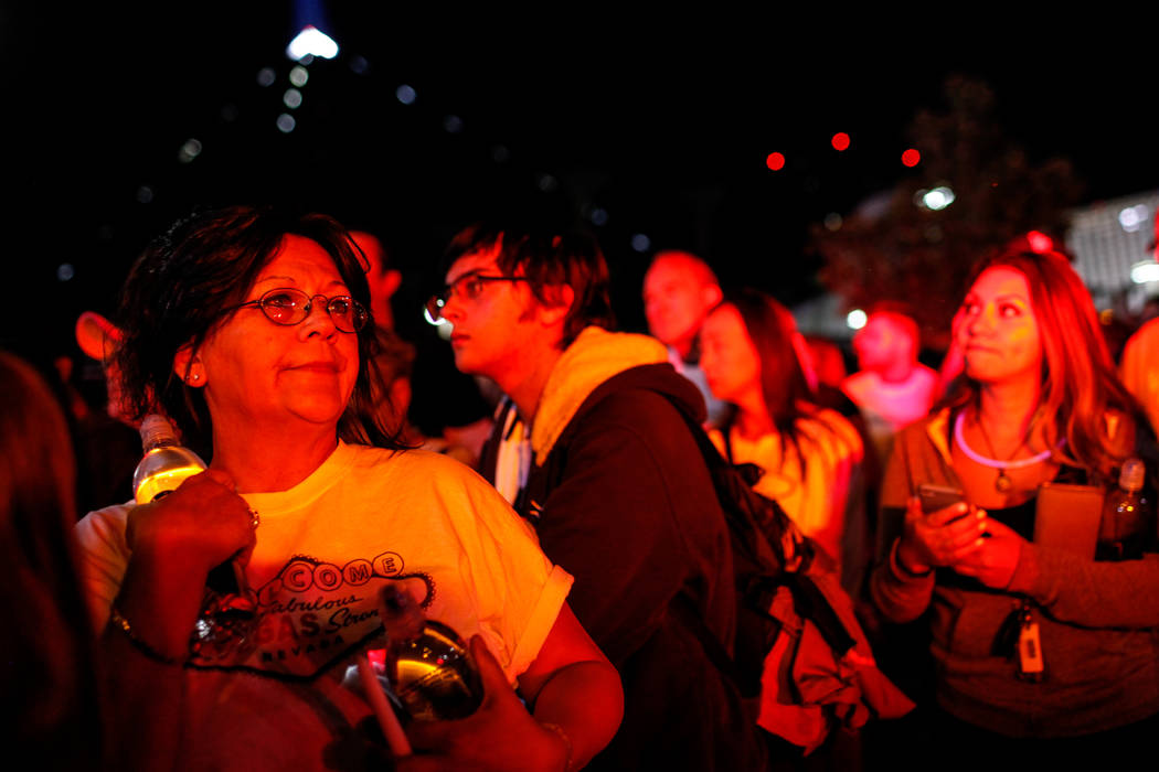 Loraine Ortega of Las Vegas, 56, gathers across Mandalay Bay during the Vegas Strong Las Vegas Strip Walk honoring the victims of the Route 91 Harvest Festival shooting in Las Vegas, Sunday, Oct.  ...