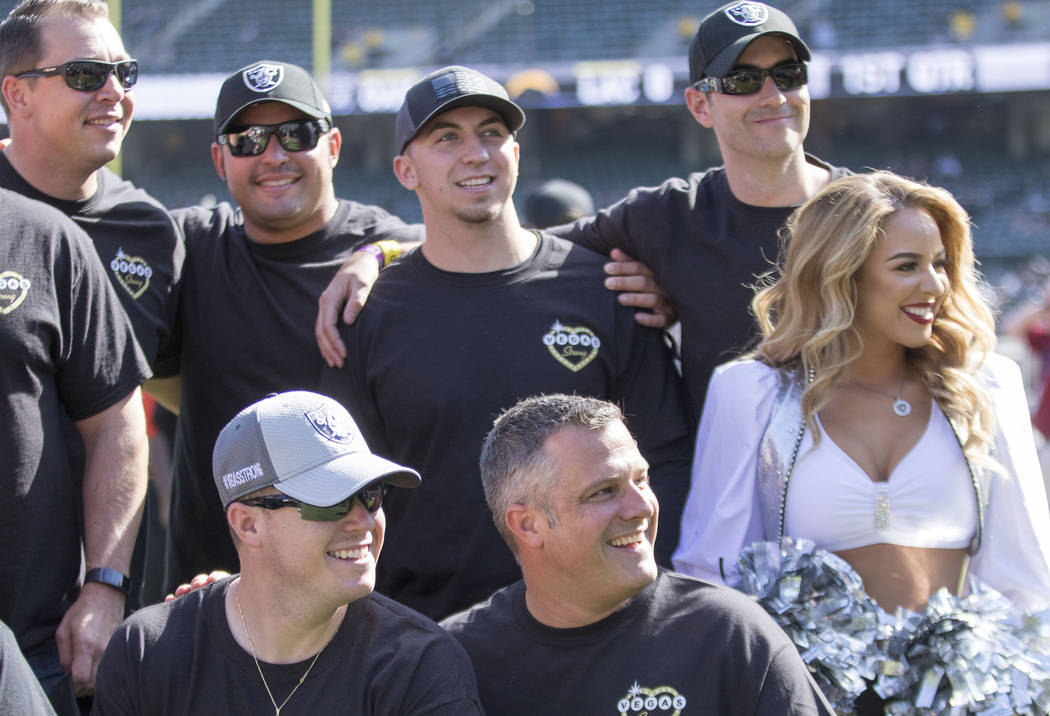 First responders from the Las Vegas shooting meet with a Raiderette before the Oakland Raiders game against the Los Angeles Chargers in Oakland, Calif., Sunday, Oct. 15, 2017. Heidi Fang Las Vegas ...