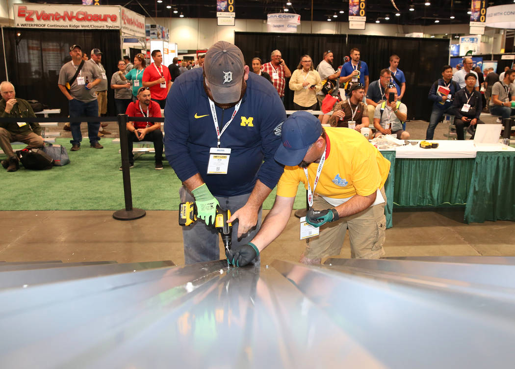 Bob Faint, left, and David Austin participate in Screw Gun Challenge during the 2017 MetalCon Expo at the Las Vegas Convention Center Wednesday, Oct. 18, 2017. Contestants install a series of self ...