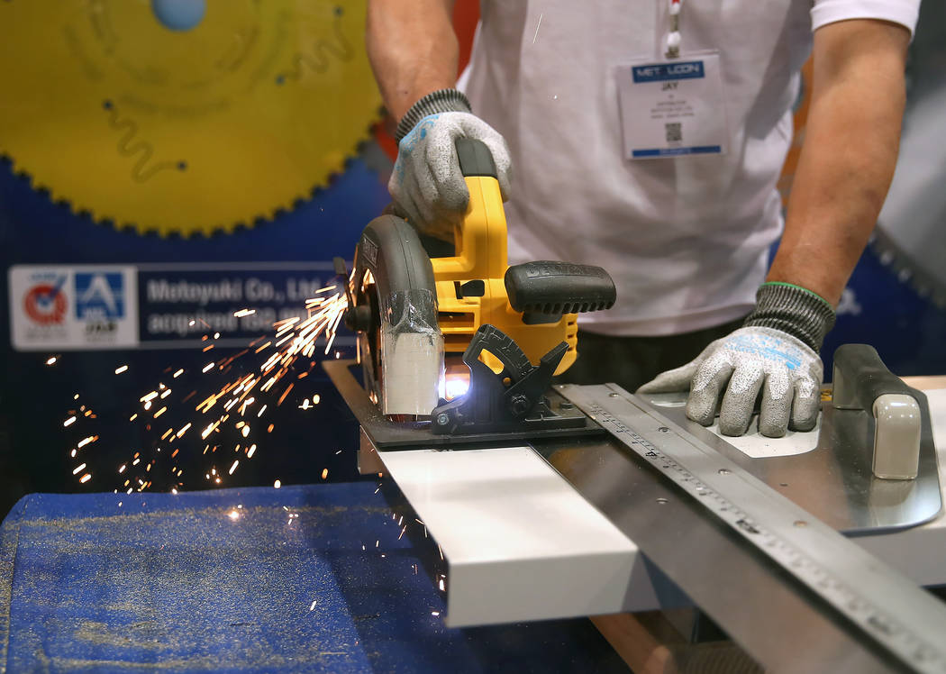 John Yu, sales manager fro Global Saw, demonstrates how he uses a circular saw blade to cut sheet metal during the 2017 MetalCon Expo at the Las Vegas Convention Center Wednesday, Oct. 18, 2017. B ...