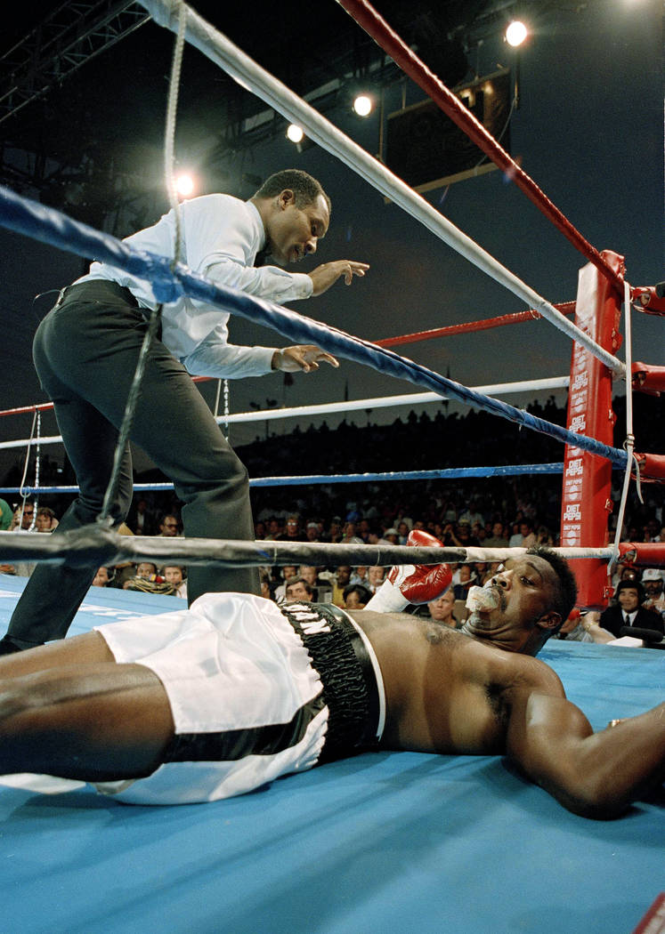 Former Olympic gold medalist Henry Tillman gets the count from referee Richard Steele after being knocked out by Mike Tyson in the first round of their bout in Las Vegas, Nev., June 16, 1990. (AP  ...