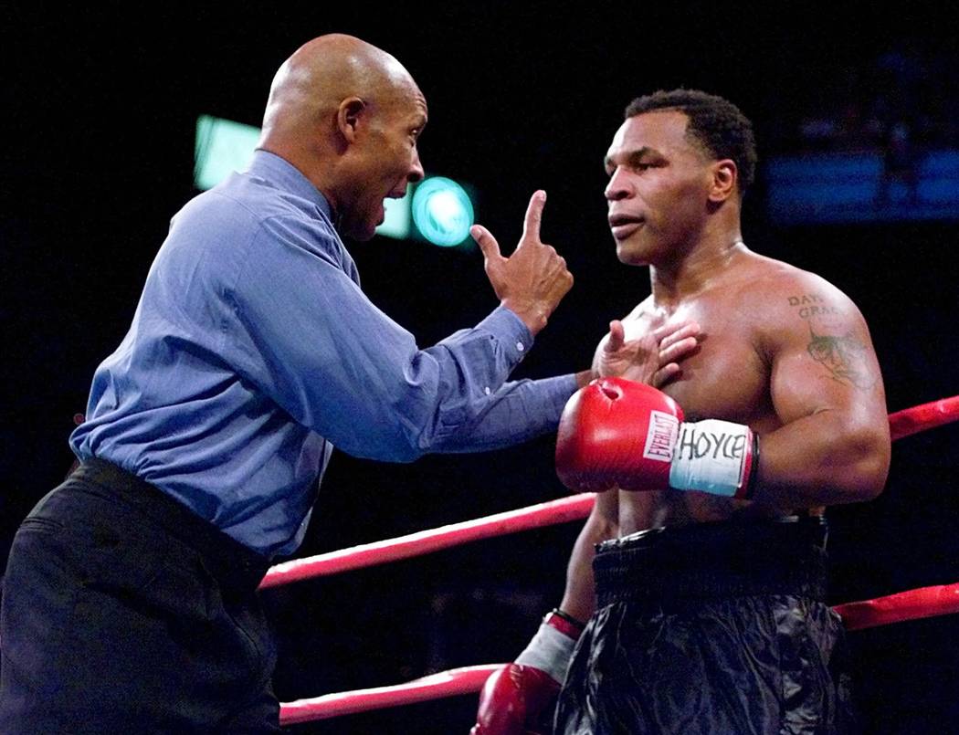 Referee Richard Steele speaks to Mike Tyson after separating him from Orlin Norris just prior to the end of the first round during their heavyweight bout at the MGM Grand Garden in Las Vegas, Satu ...
