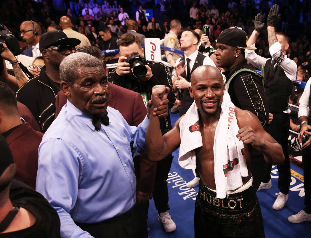 Floyd Mayweather, right, celebrates with referee Robert Byrd after his TKO victory over Conor McGregor on Saturday, Aug 26, 2017, at T-Mobile Arena, in Las Vegas. Benjamin Hager Las Vegas Review-J ...