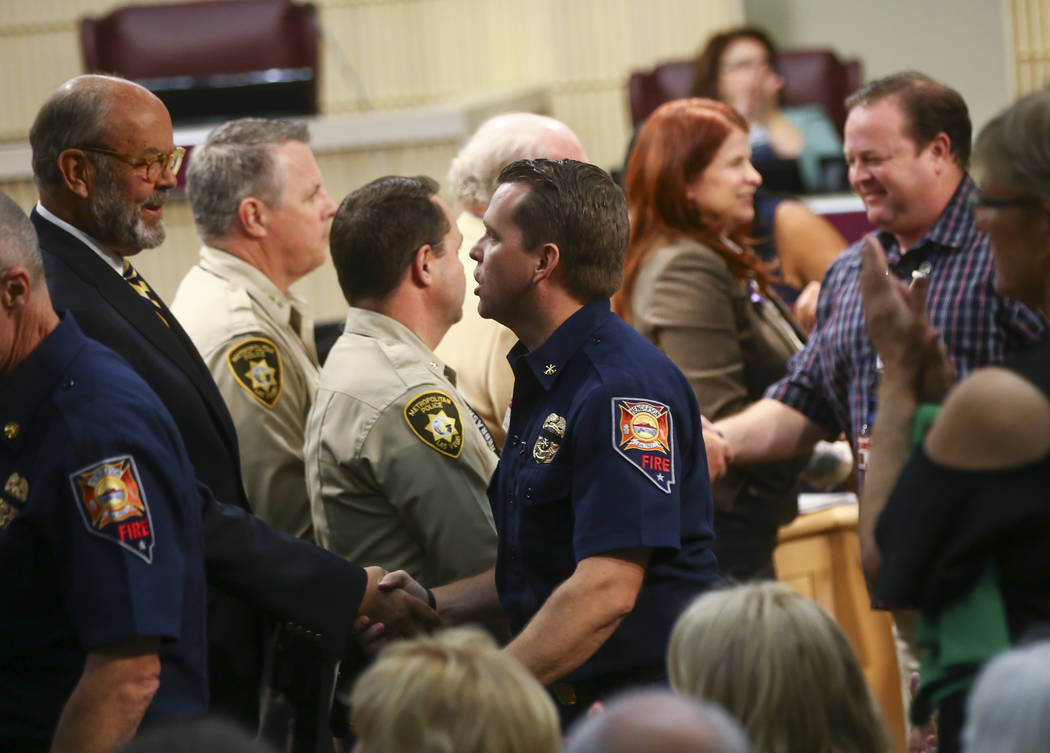 Ryan Turner, division chief of emergency management and safety at the Henderson Fire Department, center right, as first responders in the Oct. 1 shooting are recognized during a Henderson City Cou ...