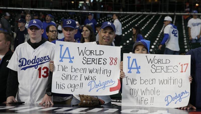 Oct 28, 2017; Houston, TX, USA; Los Angeles Dodgers fans hold up signs before game four of the 2017 World Series against the Houston Astros at Minute Maid Park. Mandatory Credit: Thomas B. Shea-US ...