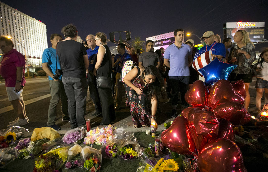 People visit a makeshift memorial for victims of the Route 91 Harvest mass shooting located on Las Vegas Boulevard and Reno Avenue in Las Vegas, Tuesday, Oct. 3, 2017. Richard Brian Las Vegas Revi ...